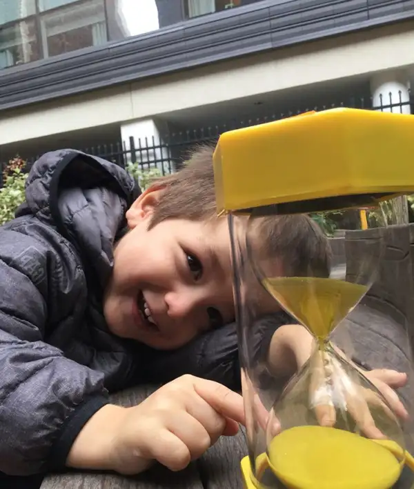 Boy with yellow hour glass